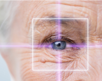 Close-up photo of an elderly woman's eye through a target of light
