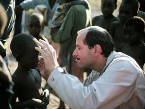 Dr. Sommer examines a child for trachoma and xerophthalmia, part of a 1989 survey in Zambia.
