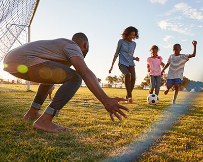 Family playing soccer, exposed to potential allergens, like pollen from grass, trees and ragweed
