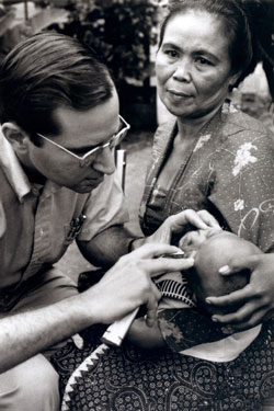 Dr. Sommer examines a child for xerophthalmia in Bandung, Indonesia, 1976.