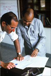 Dr. Sommer reviews data with a colleague in Nepal, 1994.