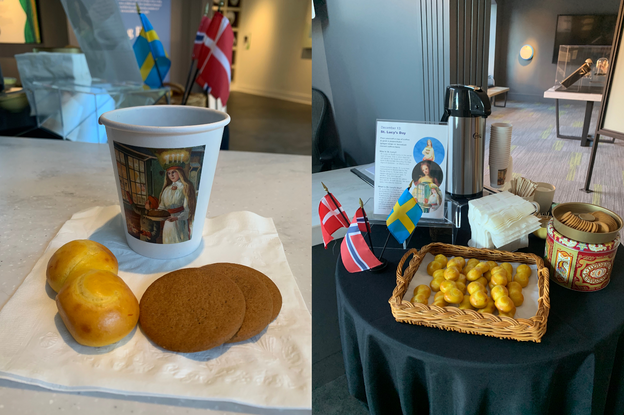Left: A photo of a cup of coffee and two baked goods. The coffee cup has a picture of a young woman in white robes with a wreath of candles around her head. One backed food is a yellow bun and the others are brown circular cookies. Small flags can be seen in the background. Right: A tabletop set up of flags, baked goods, and a coffee carafe. Yellow buns sit in a woven basked, next to a red metal tin with cookies on top. There are several small flags, and a sign with pictures of a young woman. Behind the sign, there is a large silver and black coffee carafe. 