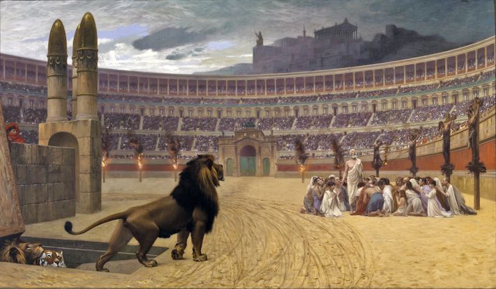 A painting of a group of people in robes huddled together in a sand-filled race course, being hunted by lions. 