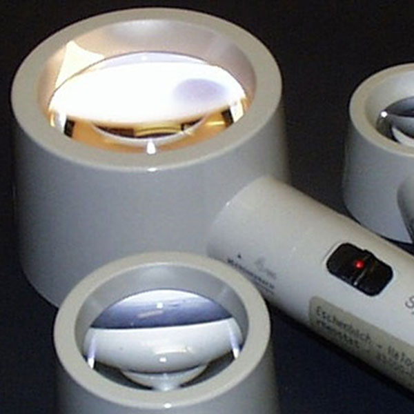 An illuminated magnifier helps people with low vision read.