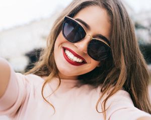 Girl wears sunglasses to protect her eyes from UV rays.