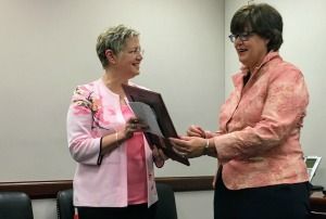 Karen Summar, MD, right, health policy director for Sen. Charles Grassley, R-Iowa, accepts an Academy Visionary Award on behalf of the senator from Academy President Cynthia A. Bradford, MD.