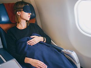 Woman removes contact lenses to nap on airplane