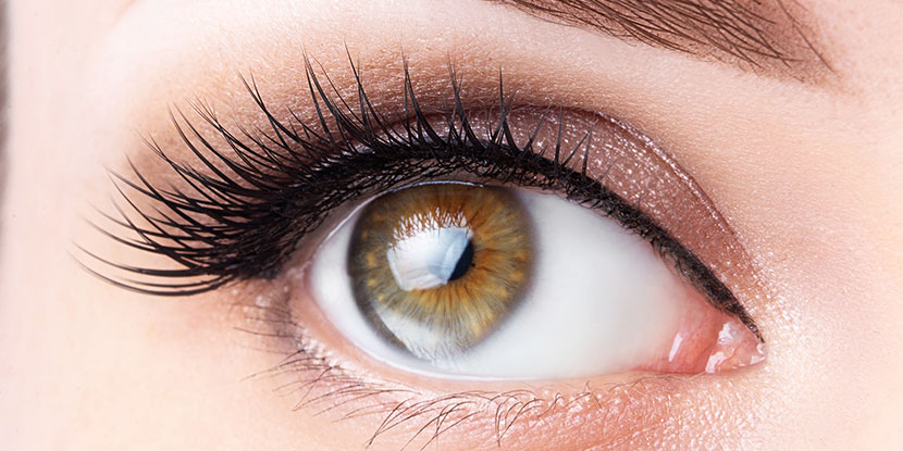 Close up of woman's eye framed by thick lashes