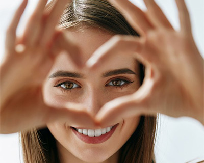 Woman making heart shape with her fingers