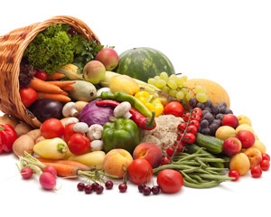 Photograph of fruits and vegetables spilling out of an overturned basket