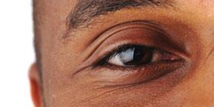 Close up of a man's eye with a brown iris