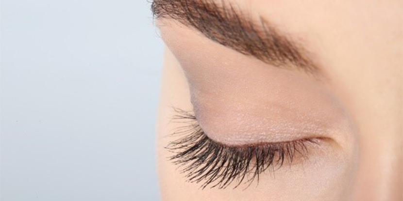 A close-up of woman's eye with long eyelashes