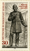 A postage stamp with an image of a man standing with his hand on his chest. The man has longer, collar-length hair and a long beard and mustache. He wears a black suit with a long black coat, and he is standing in front of stadium-style seating. The upper right hand red text reads: Albrecht von Graefe 1828-1870. The red text along the left edge of the stamp reads: 30 Deutsche Bundespost Berlin.
