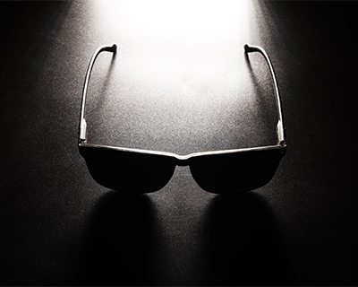 Dark sunglasses displayed in shadow