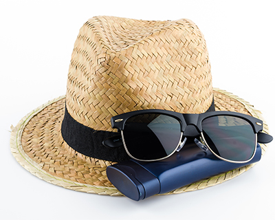 A pair of sunglasses and a straw hat displayed together