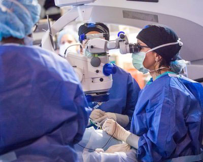 Dr. Audina Berrocal in the operating room performing a gene therapy procedure on 9-year-old patient Creed Pettit.