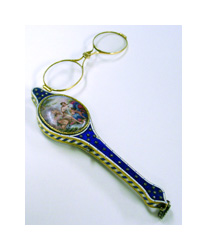 A pair of eyeglass lenses are attached to a blue and gold decorated handle with a cameo painting affixed to it. The lenses have gold frames and a small hinge in between the lenses to fold them in half.