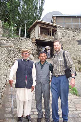 Dr. Kietzman with a cataract patient. Note the stone wall behind them, typical of Gilgit construction."