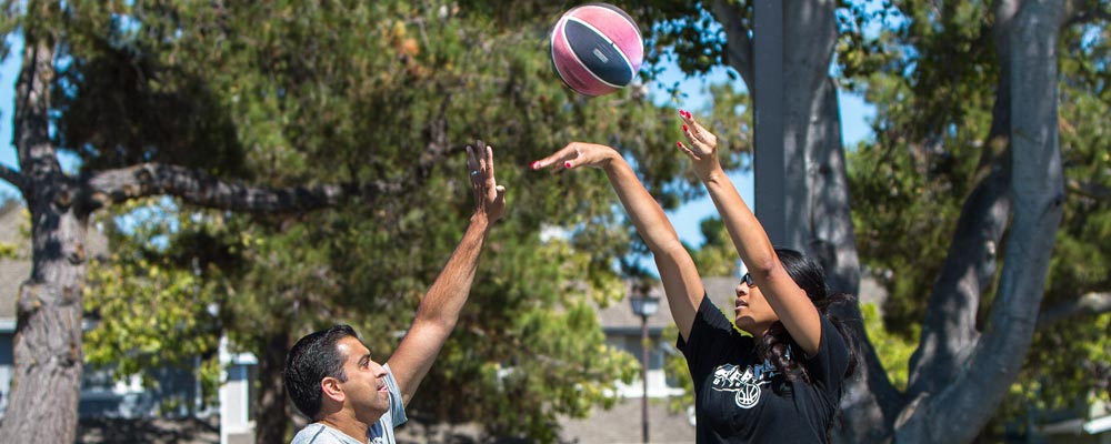 Dr. Khurana and Angellia play a game of one-on-one basketball