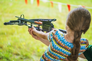 Girl aiming crossbow