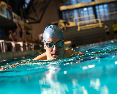 Photograph of a person swimming in a pool