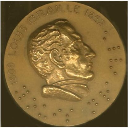 A gold metal coin with the image of a man's face in profile. The top edge of the coin reads 1809 LOUIS BRAILLE 1852. The bottom edge has raised, textured dots indicating Braille writing.