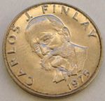 A gold-colored coin with a mustachioed man's face. The man wears eyeglasses and has a handle-bar style mustache. The top of the coin reads: Carlos J Finlay. The bottom of the coin reads: 1975.