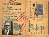 Two pages from an identity card or passport book. The paper is weathered and beige. One page has a small black and white photograph of a man with heavy framed eyeglasses and a mustache, and the other page has a large visa stamp. Both pages have several fields of illegible handwriting in blue ink. The text across the top of the first page reads: Carte d'identite.