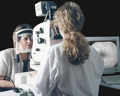 A middle-aged woman having fluoriscein angiography done so her ophthalmologist can look more closely at her retina