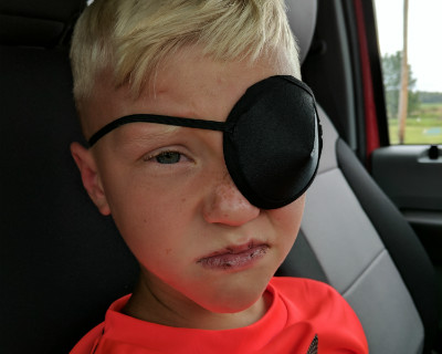 Colton Thompson wears eye patch after being injured by a fish hook in the eye.